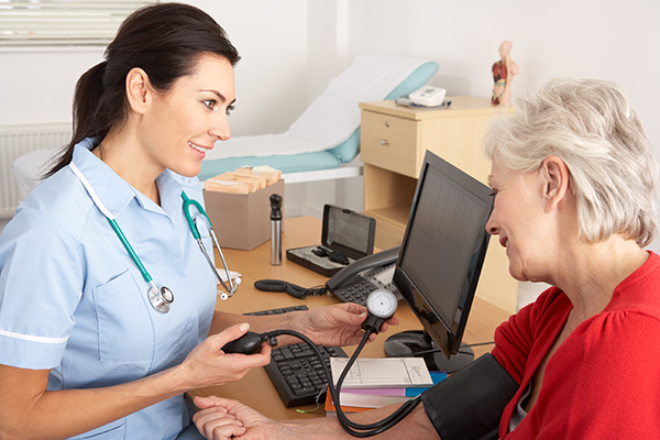 Image of a doctor taking a patient's blood pressure